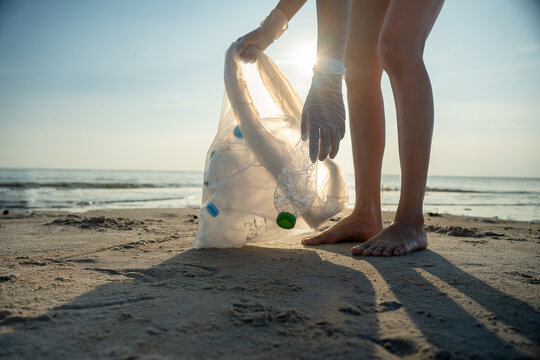 Save Water. Volunteer Pick Up Trash Garbage At The Beach And Plastic Bottles Are Difficult Decompose Prevent Harm Aquatic Life. Earth, Environment, Greening Planet, Reduce Global Warming, Save World