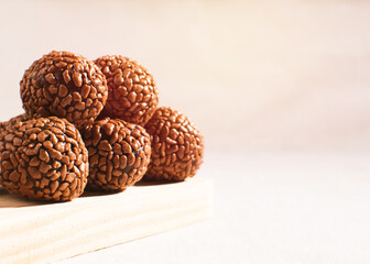 Brazilian chocolate truffles (brigadeiro gourmet), a chocolate ball candy, copy space, side view, space for text, white background, focused, isolated
