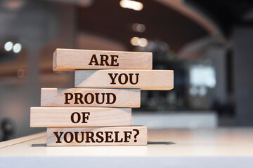 Wooden blocks with words 'Are You Proud Of Yourself?'.