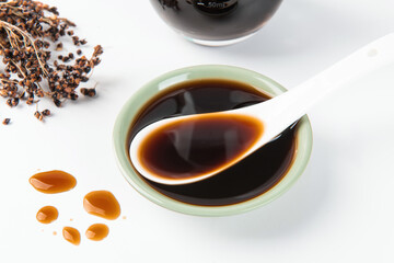 Bowl with traditional vinegar on white background.