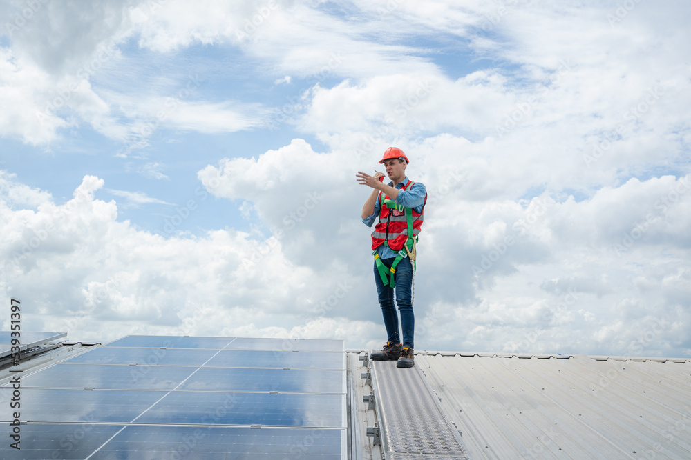 Poster solar power,engineer inspect solar panels on the roof of a factory where solar panels are installed 
