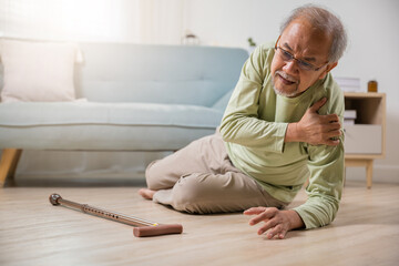 Sick senior old man falling down lying on the ground because stumbled at home alone with wooden...