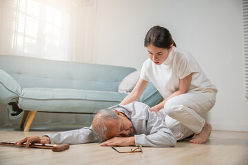 Asian elderly old man with walking stick fall on ground and granddaughter camp to help to support...