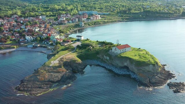 Aerial view of beautiful cape in Tsarevo with small church standing on top of the rocky hill