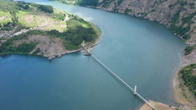Aerial view of pedestrian bridge for the village of Lisitsite over Studen Kladenets Reservoir, Kardzhali Region, Bulgaria