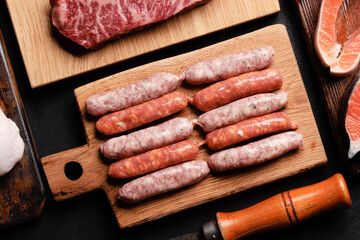 Various raw meat and fish. Steaks, sausages, salmon, chicken and spices