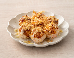 Homemade rice ball in takoyaki style on wooden table background.