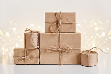 Christmas sustainable gift boxes composition on shining bokeh background. Christmas zero waste, boxing day and winter holiday