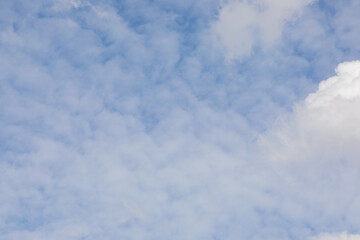 Cloudy daytime sky can be used as a background image.