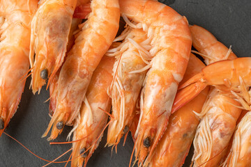 Delicious sauteed shrimp heart with cajun seasoning and lime on dark stone