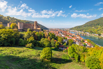 Hillside view from the grounds of the Heidelberg Castle Complex of the medieval Palace ruins, old town, bridge and Neckar River in the Bavarian city of Heidelberg, Germany. - obrazy, fototapety, plakaty