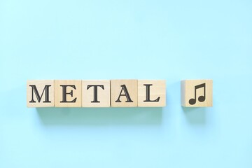 Metal music genre or style concept. Creative flat lay typography composition in blue background.