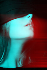 Obraz premium Beauty, sensual, make-up concept. Close-up studio shot of beautiful woman face covered with black ribbon in red and blue color split effect. Black and white image. Futuristic looking style