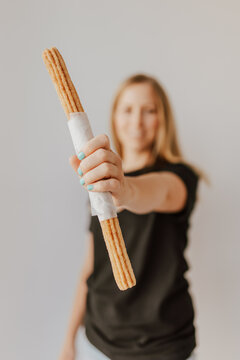 Girl Holding Churro On White Background With Blurred Face