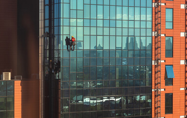 High-rise workers wash the facade and glass of a skyscraper