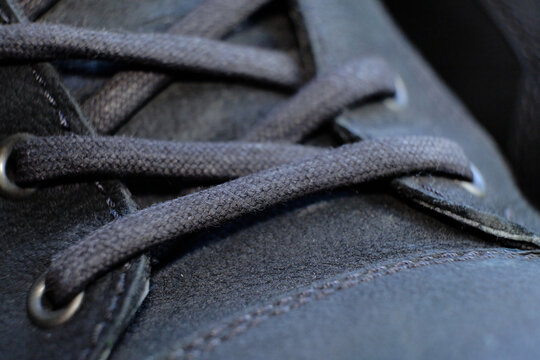 close-up details waterproof men's black boots. Drops of rain on suede shoes.