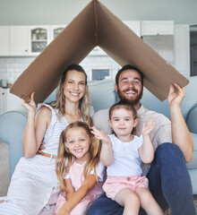 Safety, happy and portrait of family with a roof or covering gesture with cardboard in the living...