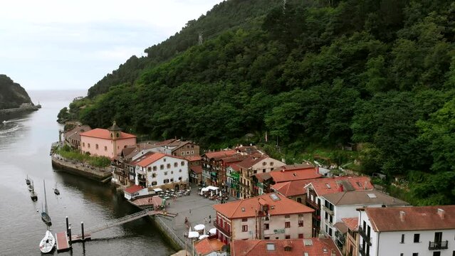 Drone shot of colorful houses of the fishing town of Pasajes de San Juan near Cantabrian Sea.