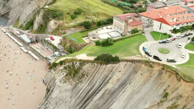 Aerial shot of flysch abrasion platform and cliffs at Zumaya. Beach and town in the background.