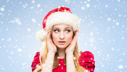 Portrait of young and pretty girl in Santa hat. New year and Christmas concept.