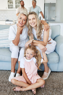 Mother, daughter and child with smile for photo in the living room of their house together. Portrait of a happy, relax and calm child with her grandmother and mom during a visit in the lounge