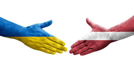 Handshake between Latvia and Ukraine flags painted on hands, isolated transparent image. - obrazy, fototapety, plakaty
