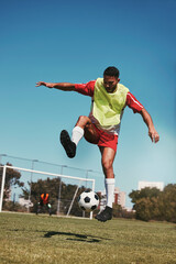 Sport, fitness and soccer training with soccer player in soccer ball power kick on a soccer field,...