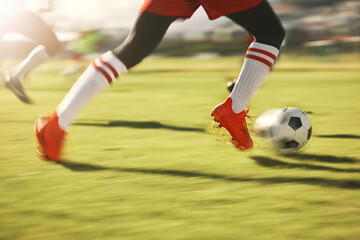 Soccer, sports and running with the shoes of a man athlete on a grass pitch or field during a game....
