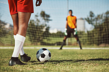Sports, soccer field and legs of athlete with goalkeeper ready for penalty kick, game or...