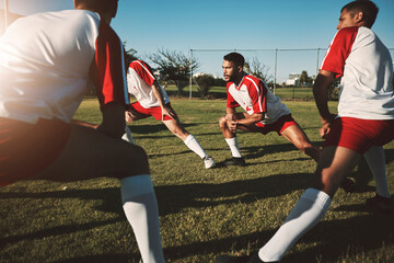 Soccer field, men and team stretching legs for match warm up, practice or game. Sports, football and group stretch outdoors on pitch in preparation for exercise, training or fitness workout on grass. © Allistair F/peopleimages.com