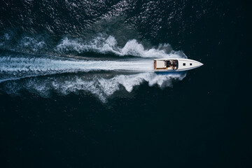 boat performance fast movement on dark water top view.
