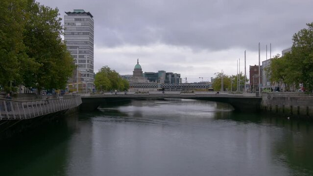 Rosie Hackett Bridge And Loopline Bridge Over Liffey River Near The SIPTU and The Custom House Buildings in Dublin, Ireland. - timelapse