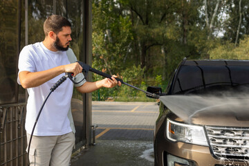 He loves his car. Man washing car.