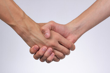 strong male handshake with bare hands on a white background
