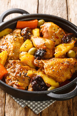 Gallo en chicha is a traditional chicken dish that is popular in El Salvador, as well as in other Central American countries closeup on the pan on the wooden table. Vertical