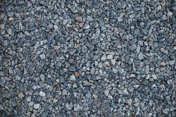 Gray small gravel background texture. black road stone and rocks.