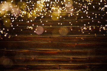 wood board in front of Christmas warm gold garland lights on wooden rustic background. glitter overlay