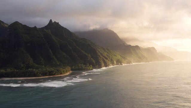 Dramatic aerial view of Napali coast from bird eye view, incredible place for visit on Kauai Hawaii island. Amazing natural landscape, Jurassic world movie filming location. 4K aerial USA.