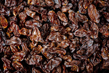 Close-up shot of freshly dried dark-colored raisins.