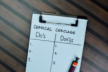 Concept of Cervical Cerclage with Do's or Don'ts write on paperwork isolated on Wooden Table.
