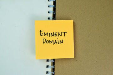 Concept of Eminent Domain write on sticky notes isolated on Wooden Table.