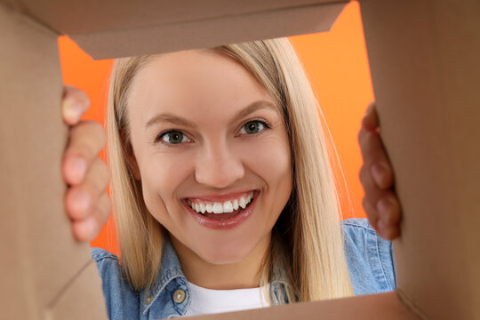 Concept of delivery, surprise, gift, young woman opened a cardboard box
