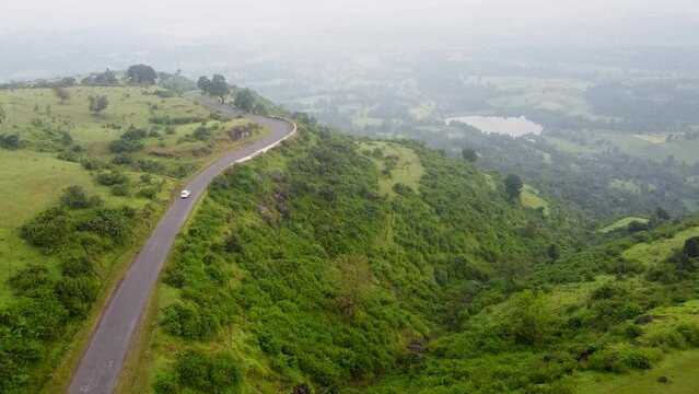 Vehicle Traveling On Scenic Mountain Road In Maharashtra, India - aerial drone shot