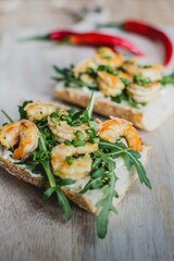 Fresh sandwich with prawns and arugula