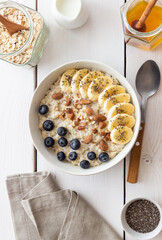 Oatmeal with banana, blueberries, almonds and honey. Healthy food. Vegetarian food. Breakfast.