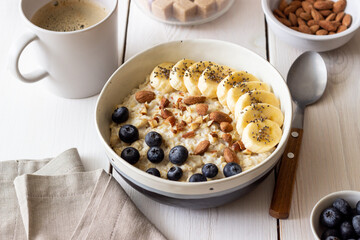 Oatmeal with banana, blueberries, almonds and honey. Healthy food. Vegetarian food. Breakfast.