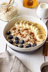 Oatmeal with banana, blueberries, almonds and honey. Healthy food. Vegetarian food. Breakfast.