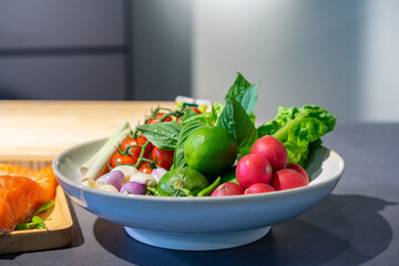 Ingredients of Spicy salad are prepared on black granite top table with various vegetable and herb.