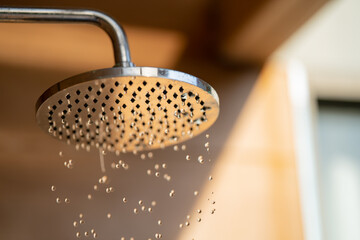 Close up to Outdoor shower head for the bath and showering cold water to body before jumping in the...