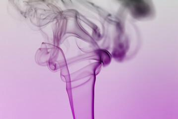 Beautiful scenic smoke of incense stick against purple background. Photo taken October 17th, 2022, Zurich, Switzerland.